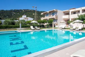 a large swimming pool in front of a building at Santa Helena Hotel in Ialysos
