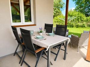 a dining room table with chairs and a white tablecloth at Chata pod Jilmy in Pelhřimov +15 photos