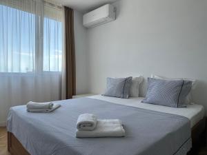 a bedroom with a large bed with towels on it at Guest Rooms Boutique Varna in Varna City