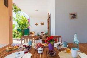 a dining room table with food and flowers on it at Sos Dorroles Motoparking in Cala Gonone +85 photos
