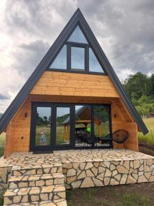 a house with a large window and a person standing outside at Forest View Kolašin in Kolašin