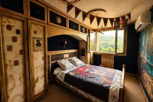 a bedroom with a bed in a train room at Ciné Lodge Lourdes in Lourdes