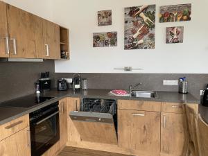 a kitchen with a sink and a stove top oven at Ferienwohnung Seeblick in Pleinfeld