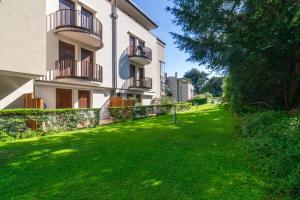 a building with a green lawn in front of it at Casa di Giò Apartment, Pool, 200m from Lake Garda in Gardone Riviera