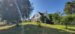 a house on a green field with a water fountain at Bolumet in Neulliac