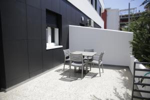 a patio with a table and chairs on the side of a building at Kron Apart Hotel Golem in Golem