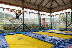 two children jumping on trampols in a tent at Apartment Anita in Westendorf