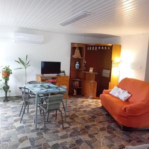a living room with a table and a couch at Cantinho Verde in Sertã