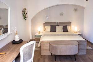 a bedroom with a large bed and two chairs at Pietro Guest House in Cortona