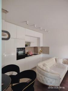 a white living room with a white couch and a table at L2 Toplica PK in Prokuplje +7 photos