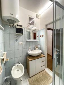 a bathroom with a toilet and a sink at Pietro Guest House in Cortona +23 photos