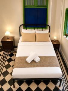 a bedroom with a bed with a pillow on it at Arvena Living in Jelutong
