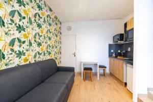 a living room with a couch and a table at Studio LEntre Nous in Saint-Pierre-de-Chartreuse +6 photos