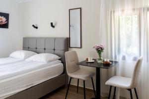 a bedroom with a bed and a table with a mirror at Hill House Orahovac in Kotor