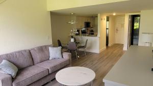 a living room with a couch and a table at Plantation Resort on Crystal River in Crystal River