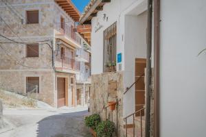 an alley in a village with buildings at La Casa De La Golondrina in Pedro Bernardo