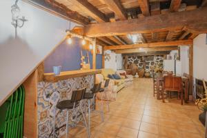 a room with a bar with chairs and a living room at La Casa De La Golondrina in Pedro Bernardo +16 photos