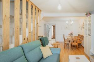 a living room with a blue couch and a table at La Casa De La Golondrina in Pedro Bernardo