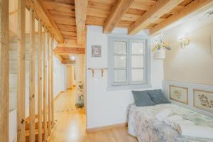 a bedroom with a bed and a window at La Casa De La Golondrina in Pedro Bernardo