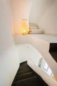 a staircase with a lamp in a white room at Stella di Mare in Procida