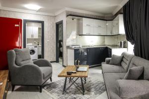 a living room with two couches and a table at Çınar Suit Hotel in Buca