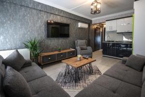 a living room with a couch and a table at Çınar Suit Hotel in Buca