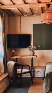 a room with a table with a vase of flowers on it at Boutique Hotel ALTENBURG in Talsi