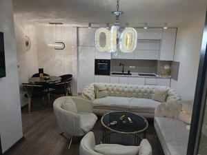 a living room with a couch and chairs and a kitchen at L2 Toplica PK in Prokuplje