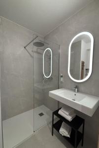 a bathroom with a sink and a shower with a mirror at B&B HOTEL Bastia in Bastia +58 photos