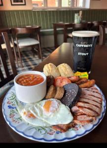 a plate of breakfast food with eggs sausage and beans at Pairc House Hotel in Birmingham +39 photos