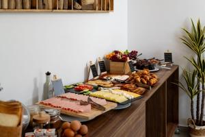 a buffet with meats cheese and other foods on a table at Neya Elements in Lartos