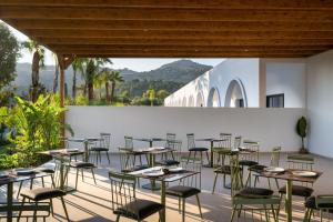 a group of tables and chairs on a patio at Neya Elements in Lartos