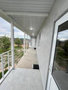an open door of a house with a porch at Kabyl Guest House in Tossor