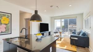 a kitchen and living room with a large counter top at The Carter by AvantStay in Nashville