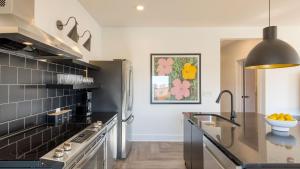 a kitchen with a sink and a refrigerator at The Carter by AvantStay in Nashville