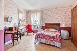 a bedroom with a bed and a desk and a table at Le Clos Mazerolles in Cruzy +63 photos