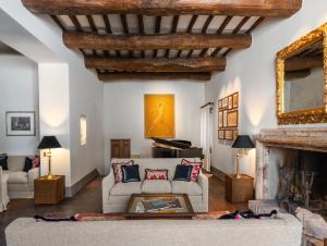 a living room with a couch and a fireplace at Borgo Tre Vaselle in Torgiano +29 photos