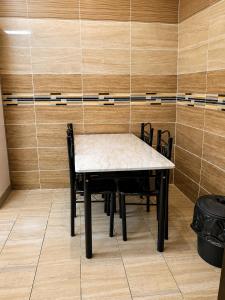 a table and chairs in a room with wooden walls at البساتين هومز - Al Basateen Homes in Al Baha +9 photos