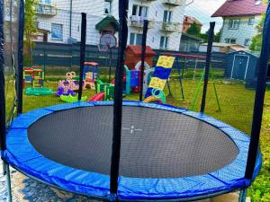 a playground with a blue trampoline in a yard at Pensjonat Semida in Władysławowo