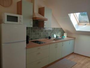 a kitchen with a white refrigerator and a sink at Apartament Miłków Karkonosze in Miłków