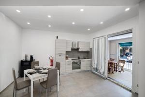 a kitchen and dining room with a table and chairs at Sea House Superior in Pietra Ligure