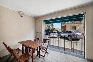 a dining room with a table and chairs and a balcony at Sea House Superior in Pietra Ligure
