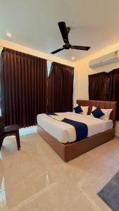 a bedroom with a bed and a ceiling fan at Hotel Vakula Matha Grand in Tirupati