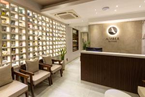 a restaurant with a lobby with chairs and a counter at Hotel Amber Seaside in Hulhumale