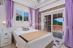 a bedroom with purple curtains and a bed with a window at TEKCE Yeşilüzümlü Villa No 17 in Uzumlu +43 photos