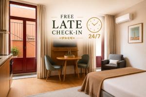 a hotel room with a bed and a table and chairs at Uma Formosa Apartments in Porto +115 photos