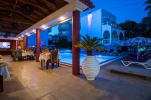 a large vase with a plant in it on a patio at Perla Marina Hotel in Ialysos