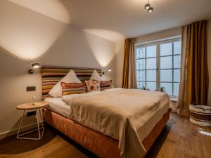 a bedroom with a large bed and a large window at Landhaus Sylter Hahn in Westerland +139 photos