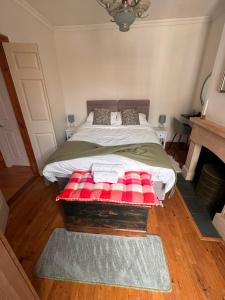 a bedroom with a large bed with red and white blankets at Railmans Rest in Faversham
