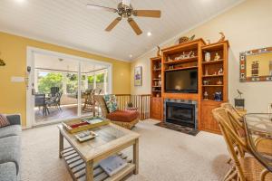 a living room with a fireplace and a tv at 3021 - Southern Snores in Kitty Hawk Beach